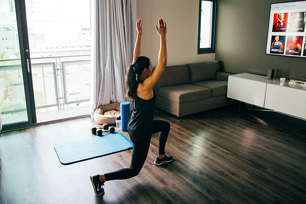 Woman doing Beachbody workout in her living room