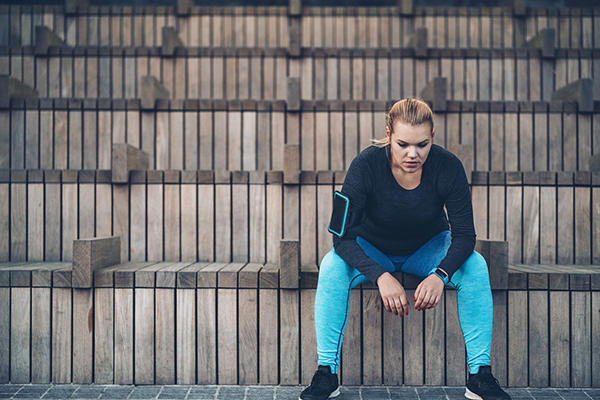 Woman in exercise clothes taking a break