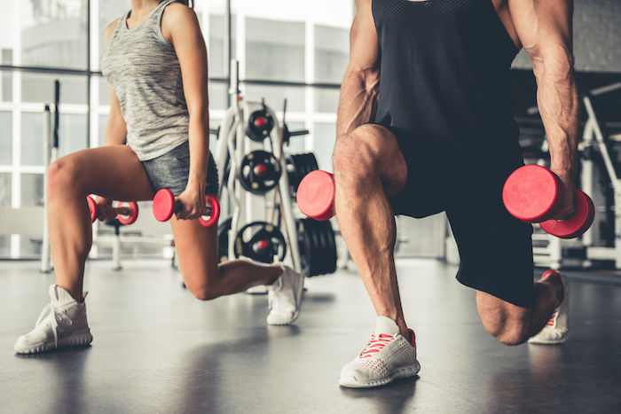 fitness couple doing dumbbell lunges | strength training workout