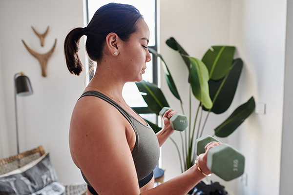 Woman doing weight lifting workout at home