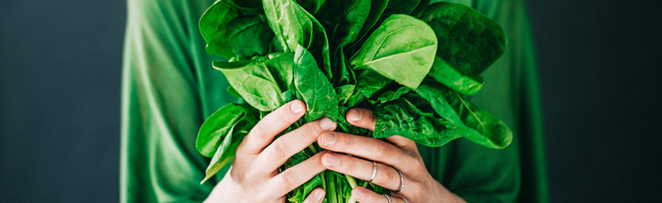 Woman holding spinach leaves