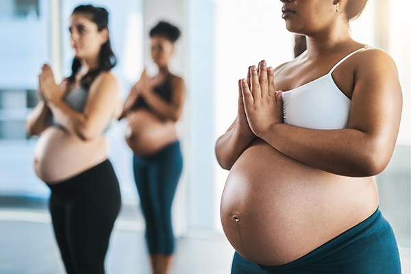 pregnant women practicing yoga