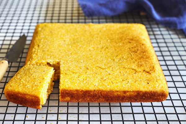 Classic cornbread fresh from the oven, cooling on a rack.