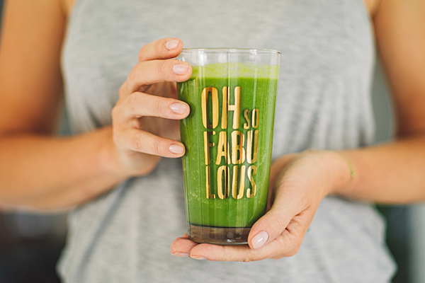 Glass of green smoothie with greens supplement