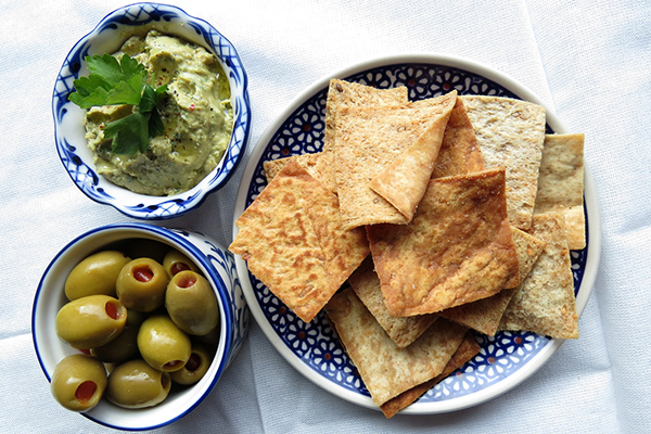 Kale hummus with olives and pita chips