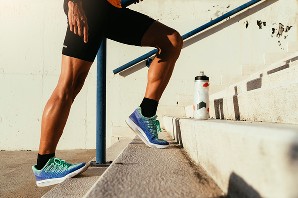 leg shot of man climbing stairs | calves workout exercises