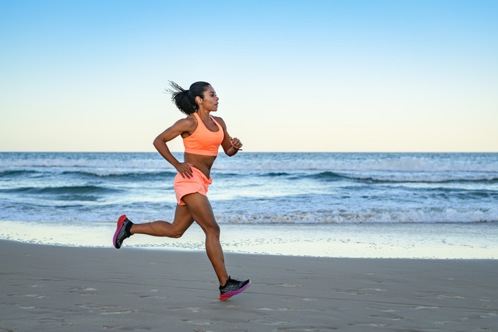 woman running on beach | Aerobic vs Anaerobic Exercise