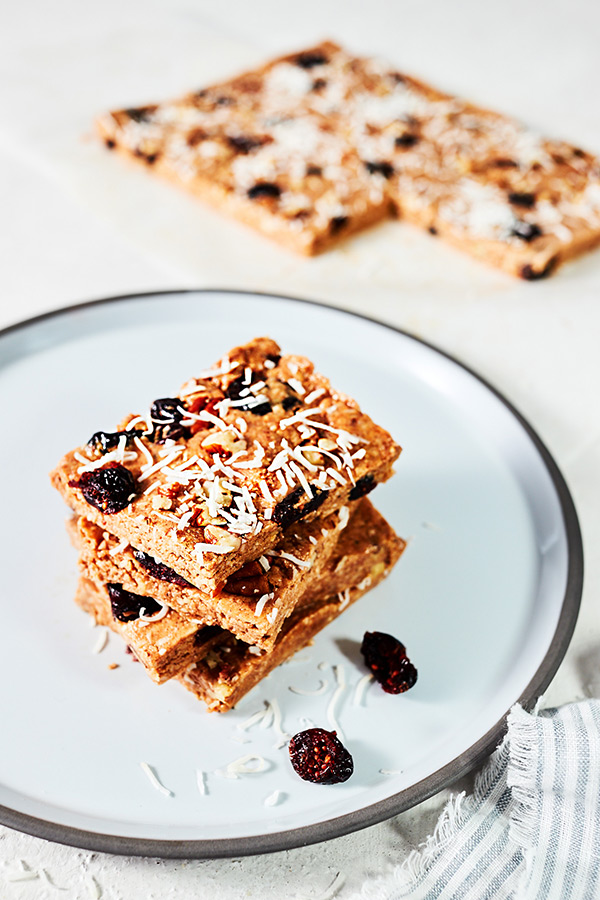 These Cranberry Bliss Bars taste just like the original only these are healthier, with smooth almond butter, shredded coconut, and pumpkin pie spice.