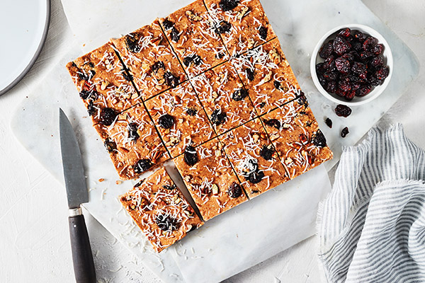 These Cranberry Bliss Bars taste just like the original only these are healthier, with smooth almond butter, shredded coconut, and pumpkin pie spice.