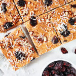 These Cranberry Bliss Bars taste just like the original only these are healthier, with smooth almond butter, shredded coconut, and pumpkin pie spice.