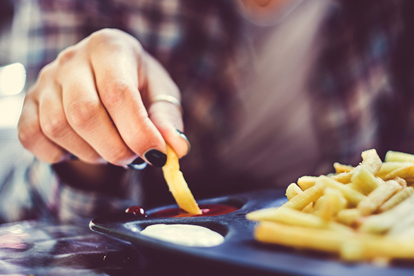 Woman eating french fries