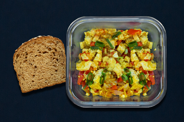 Pre-workout meal for 80 Day Obsession Vegan tofu scramble with peppers, onions, and green onions with a piece of toast.