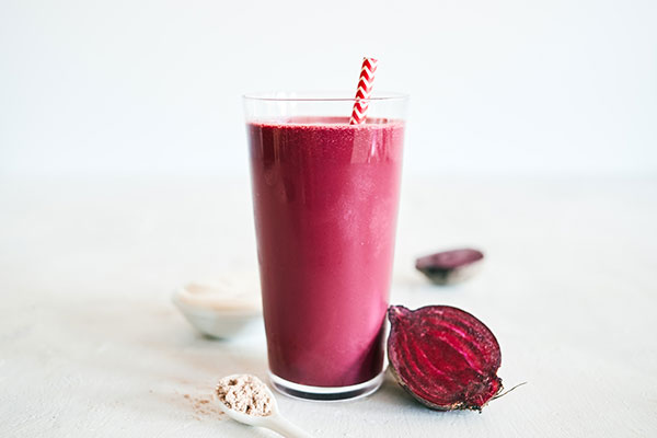 This decadent Red Velvet Smoothie features creamy Chocolate Shakeology, tangy balsamic vinegar, and fresh beet juice for that classic crimson hue.