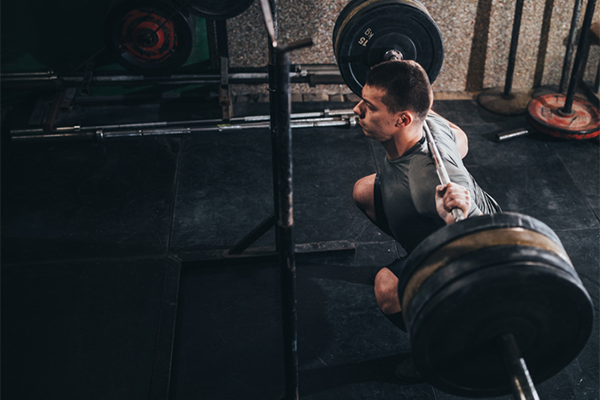 man doing barbell squat | bodybuilding tips