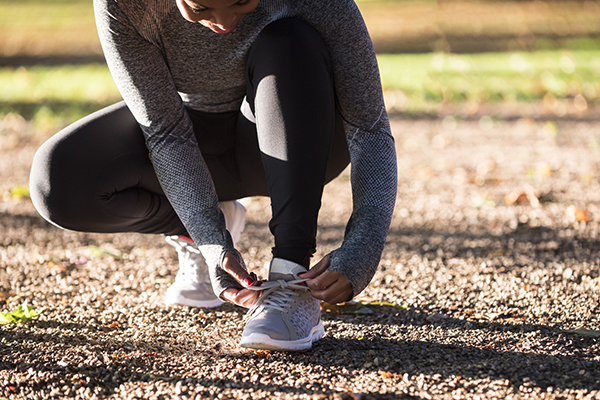 Woman tying her running shoe