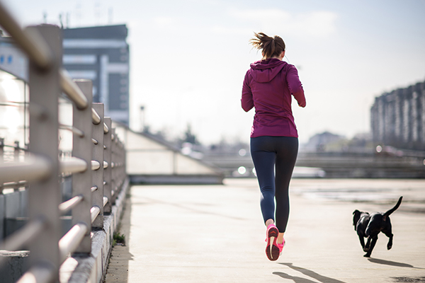 Woman running with her dog