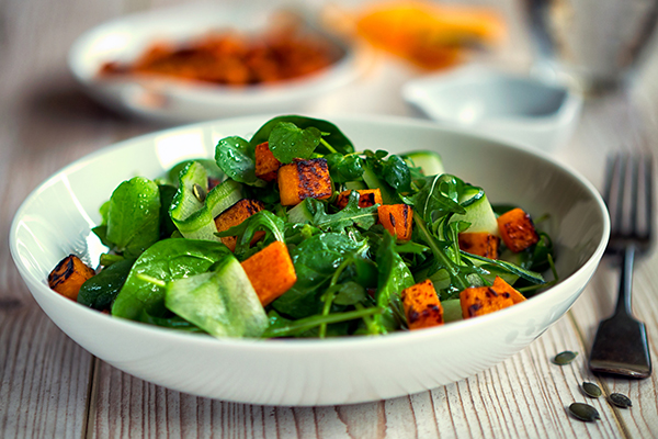Healthy salad with greens and roasted sweet potatoes