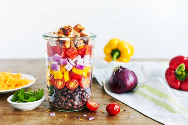 This Southwest Chicken and Black Bean Salad is bursting with flavor, thanks to black beans, crisp bell peppers, shredded cheddar cheese and grilled chicken.