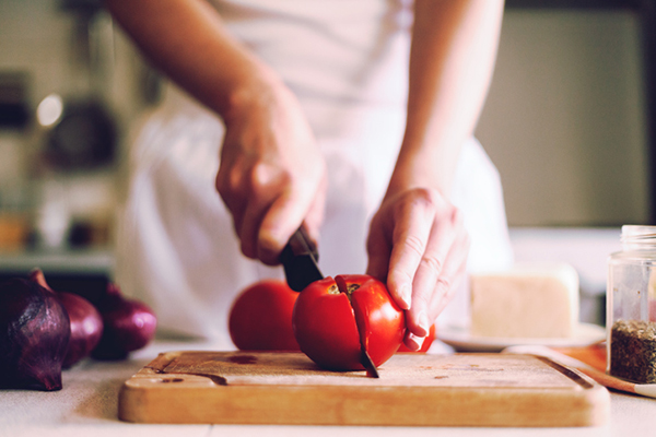 Woman slicing tomatoes