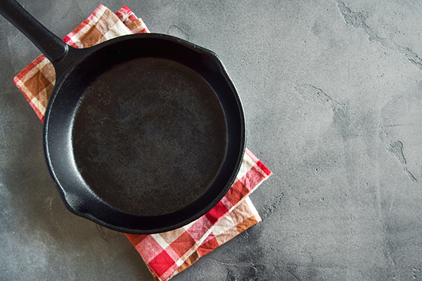 Cast iron pan on black background