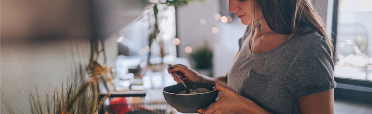 Woman eating breakfast from a bowl