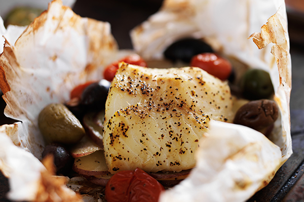 Baked fish in parchment paper