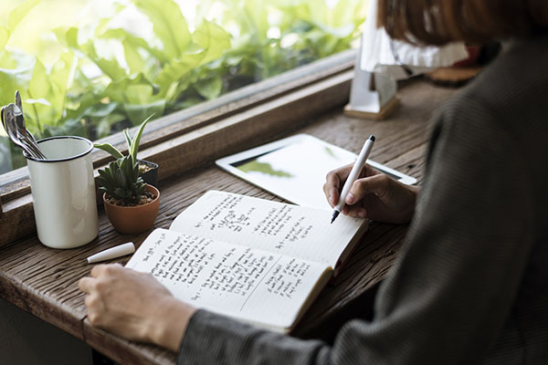 Woman writing down a meal plan