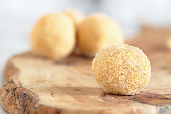 Eggnog Protein Balls on wooden cutting board