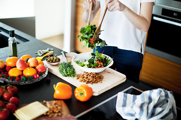 Woman tossing healthy salad