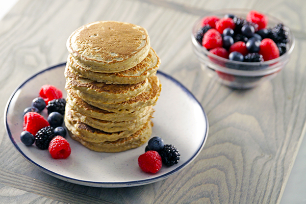 stack of pancakes and fruit on plate