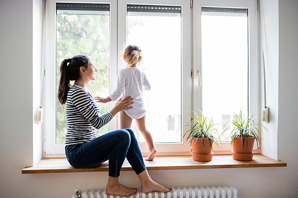 Woman and child sitting by window