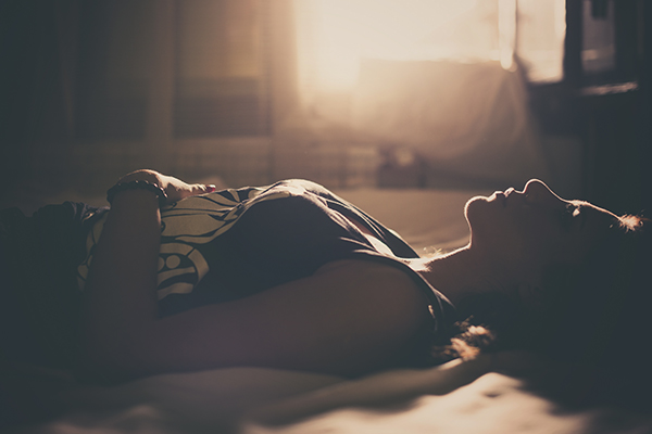 Woman lying down doing sleep meditation