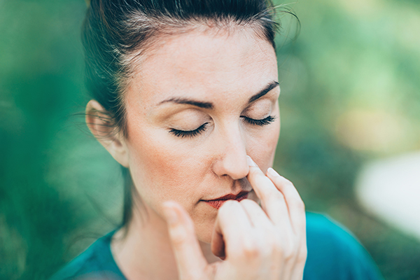 Woman doing alternate nostril breathing