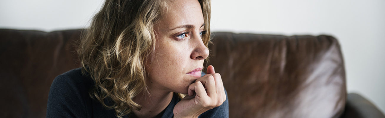 Anxious woman staring out window