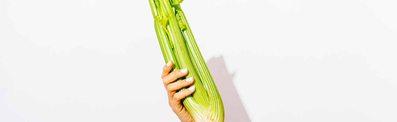 Hand holding celery bunch