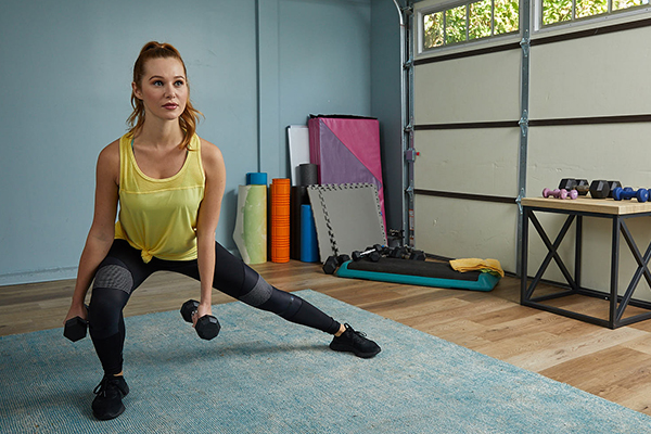 Woman exercising in home gym