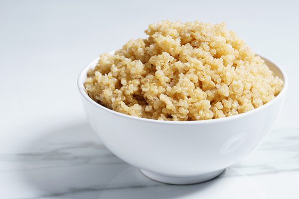 Cooked quinoa in white bowl