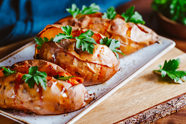 Three baked sweet potatoes on a plate