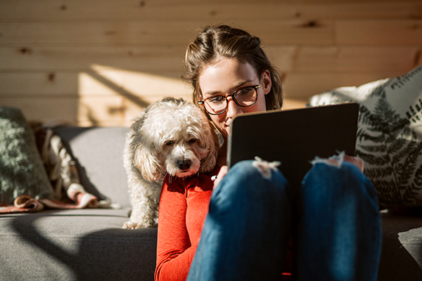 Happy woman at home with dog