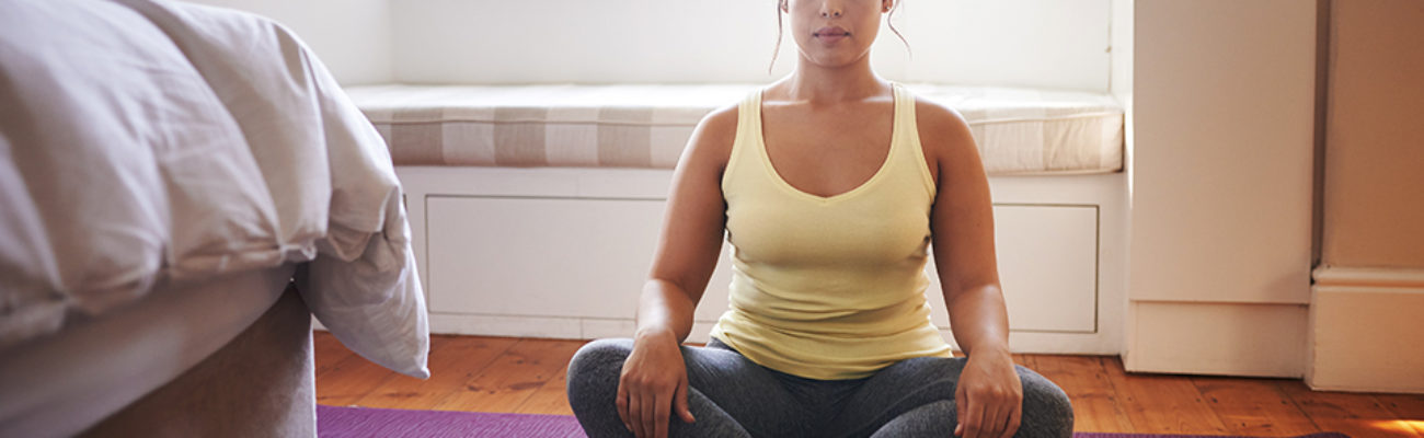 Woman meditating at home