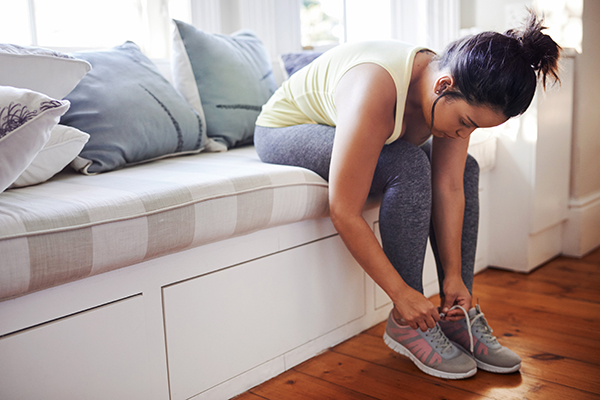 Woman tying running shoes