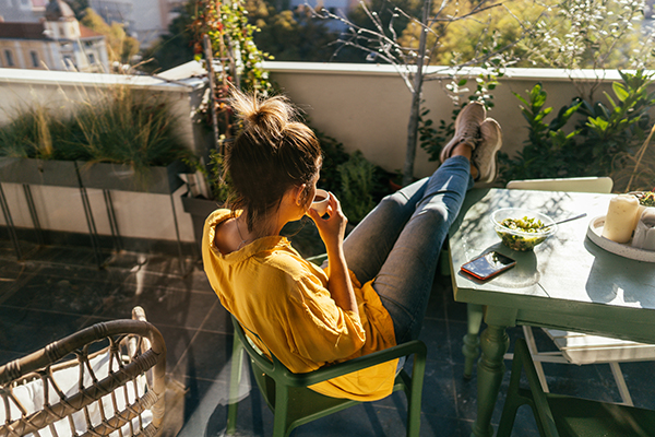 Woman eating on balcony