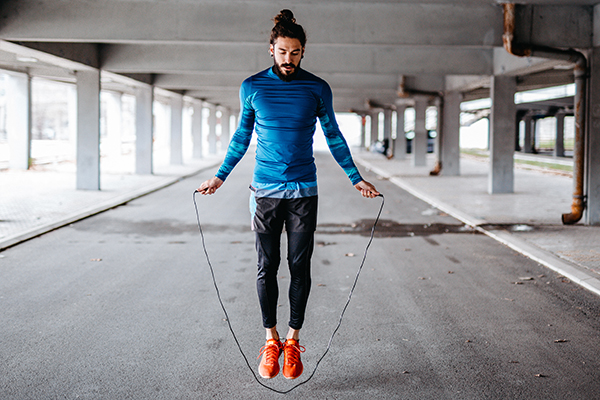 Man jumping rope outdoors