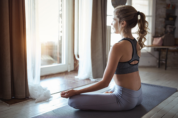 Young sporty woman meditating