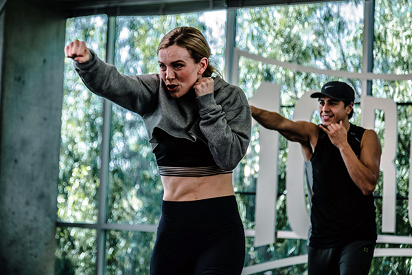 Woman throwing a jab in 10 Rounds workout