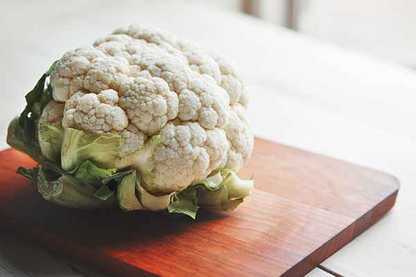 Head of cauliflower on cutting board