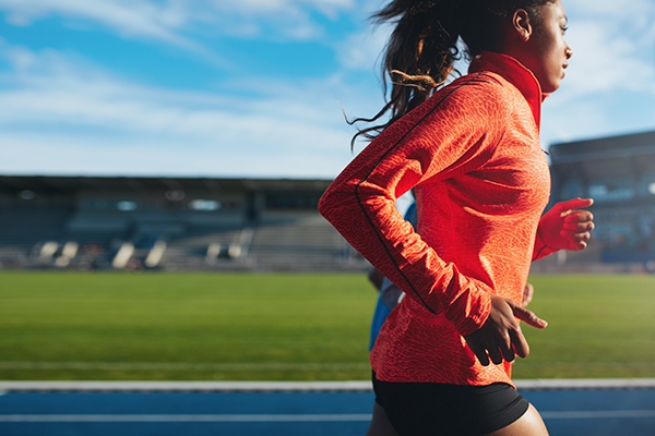 Female athlete training on race track