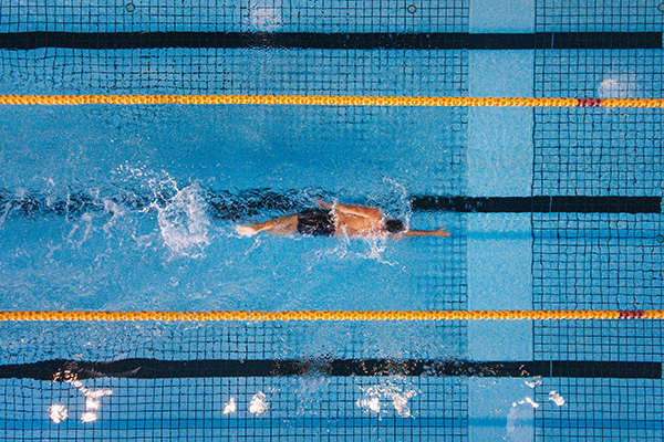 Man swimming laps in pool