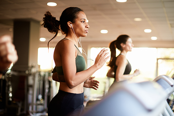 Young woman exercising on treadmill