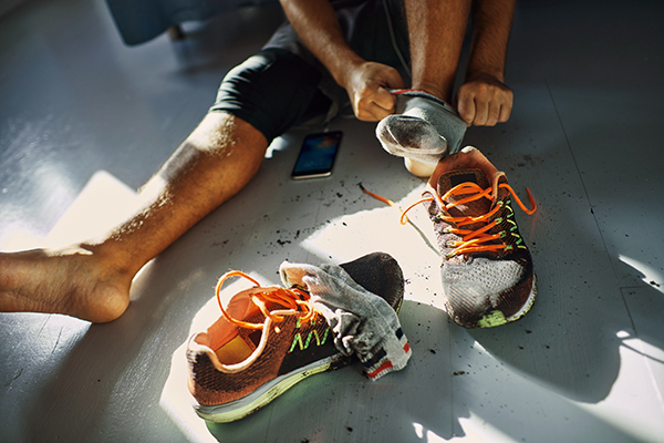 Man taking socks off after a run